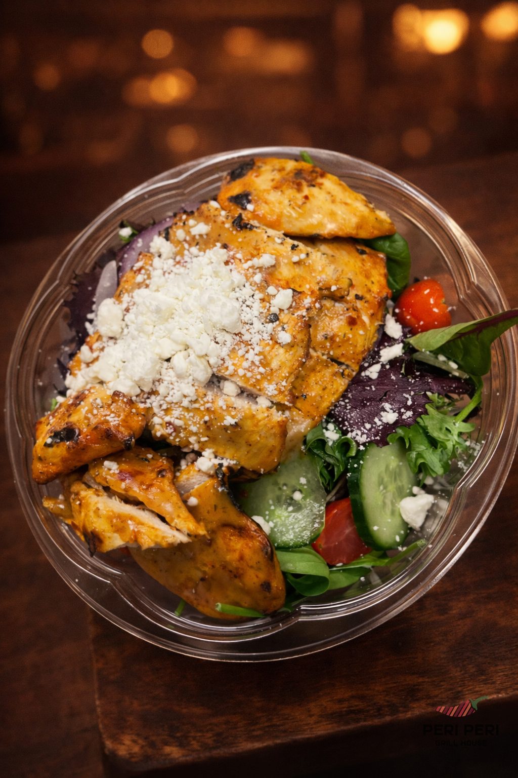 Halal peri peri grilled chicken bowl with feta, tomatoes and greens at Peri Peri Grill House