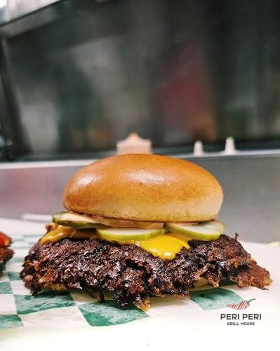 Halal smash burger with pickles and cheese at Peri Peri Grill House